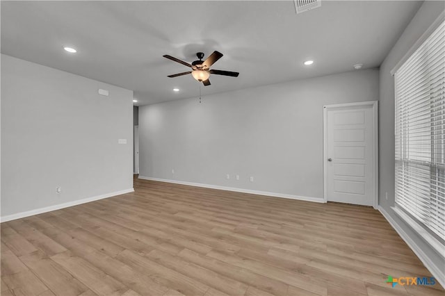 spare room with light hardwood / wood-style floors and ceiling fan