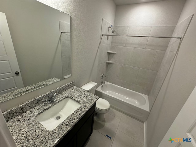 full bathroom featuring vanity, tile patterned floors, toilet, and tiled shower / bath combo