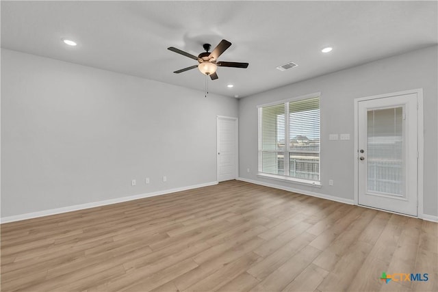 spare room featuring ceiling fan and light hardwood / wood-style flooring