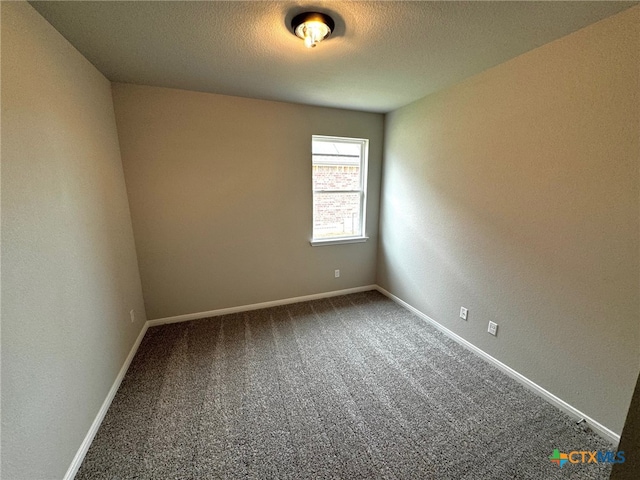 unfurnished room featuring carpet floors and a textured ceiling