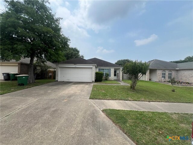 316 Clydesdale Ln, Victoria, TX 77904 - ranch-style home with driveway, a front lawn, and a garage