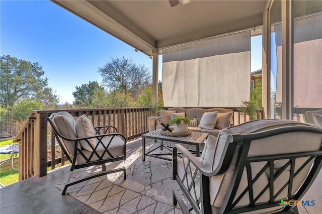 balcony featuring ceiling fan and an outdoor living space