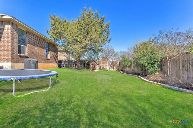 view of yard with a trampoline