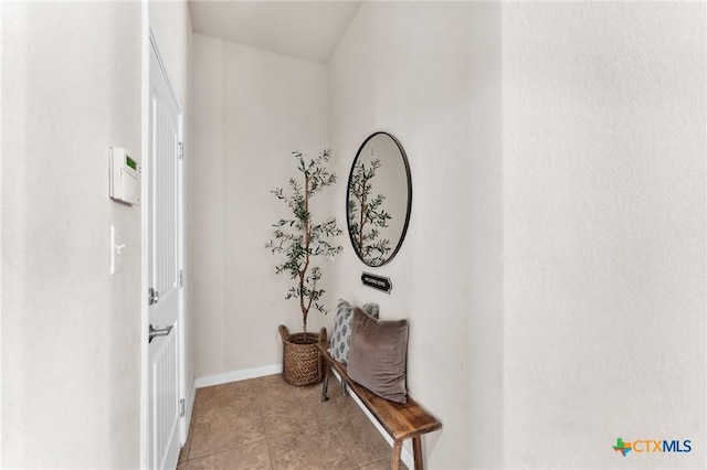 hall featuring light tile patterned floors