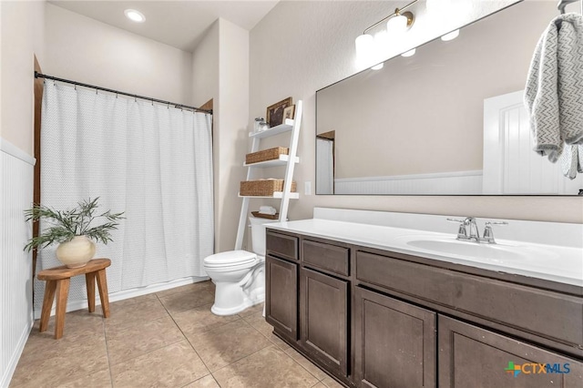 bathroom with vanity, tile patterned floors, and toilet