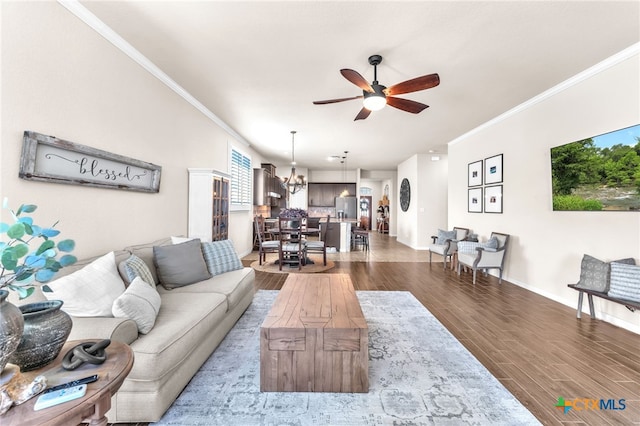 living room with hardwood / wood-style floors, ceiling fan with notable chandelier, and ornamental molding