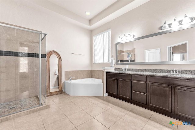 bathroom with tile patterned flooring, vanity, and separate shower and tub