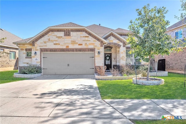 view of front of house featuring a garage and a front lawn