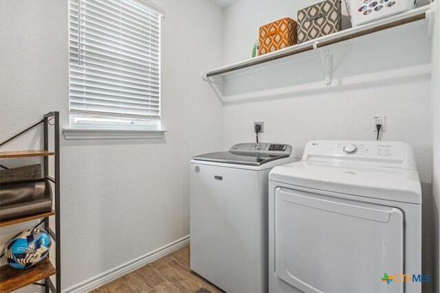 8409 Glade Dr, Temple, TX 76502 - laundry room featuring washing machine and dryer and light wood-style flooring
