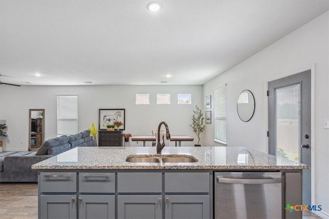 8409 Glade Dr, Temple, TX 76502 - kitchen featuring stainless steel dishwasher, gray cabinetry, open floor plan, light stone countertops, and recessed lighting