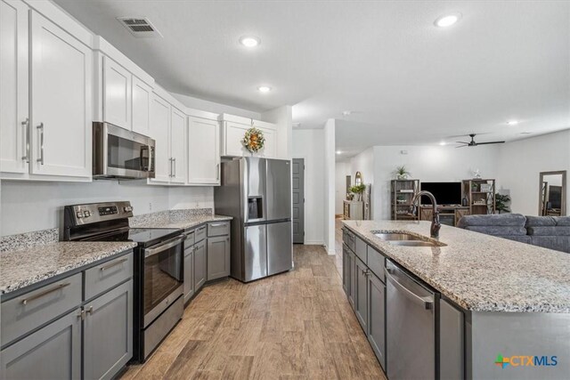 8409 Glade Dr, Temple, TX 76502 - kitchen featuring stainless steel appliances, gray cabinets, a ceiling fan, recessed lighting, and light wood-style flooring