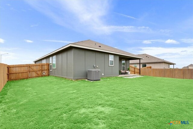 8409 Glade Dr, Temple, TX 76502 - rear view of house with board and batten siding, a fenced backyard, and a patio