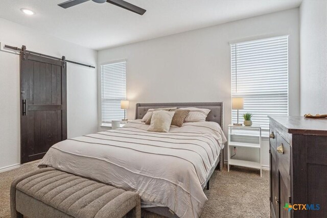 8409 Glade Dr, Temple, TX 76502 - bedroom featuring light carpet, a barn door, multiple windows, and recessed lighting