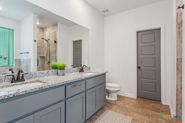 8409 Glade Dr, Temple, TX 76502 - full bathroom featuring a stall shower, double vanity, and wood finished floors
