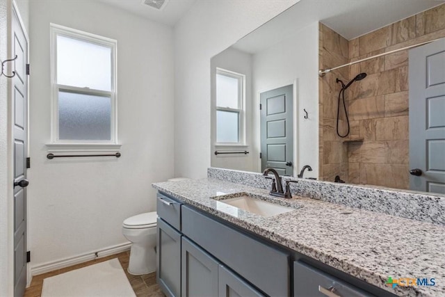 8409 Glade Dr, Temple, TX 76502 - bathroom featuring vanity, tiled shower, and wood finished floors