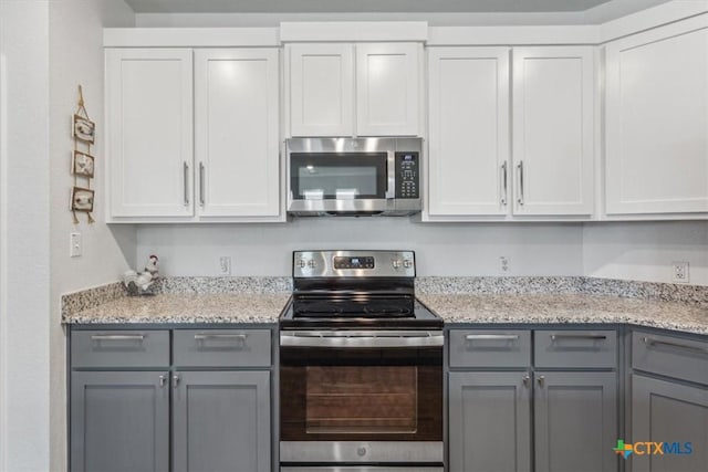 8409 Glade Dr, Temple, TX 76502 - kitchen featuring appliances with stainless steel finishes, gray cabinets, and light stone countertops
