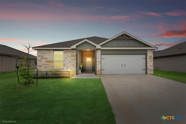 8409 Glade Dr, Temple, TX 76502 - view of front of home with driveway, an attached garage, stone siding, a front yard, and board and batten siding