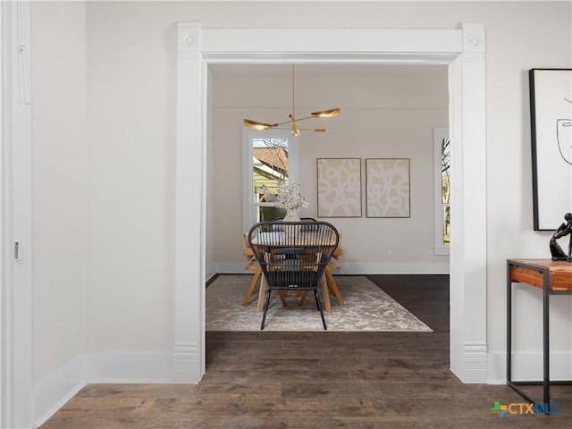 dining room with an inviting chandelier, wood finished floors, and baseboards