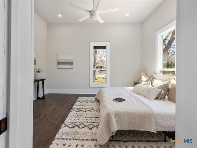 bedroom with recessed lighting, multiple windows, dark wood-style floors, and baseboards