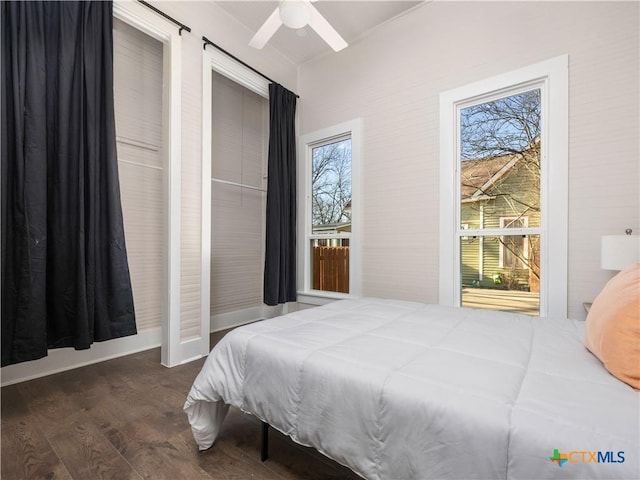 bedroom featuring a ceiling fan, baseboards, and wood finished floors