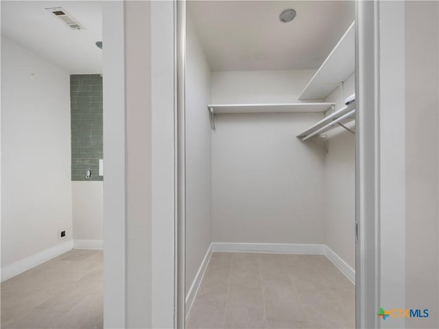 spacious closet featuring visible vents