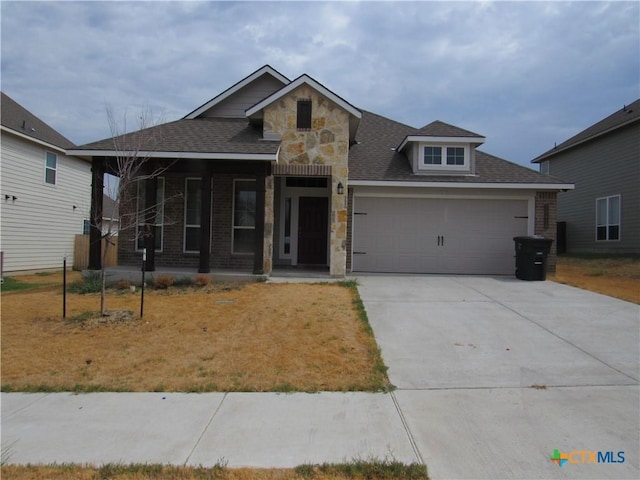 10018 Kensley Rose Dr, Killeen, TX 76542 - view of front of house featuring stone siding, a porch, an attached garage, concrete driveway, and roof with shingles