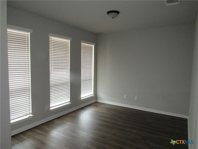 10018 Kensley Rose Dr, Killeen, TX 76542 - unfurnished room with baseboards and dark wood finished floors
