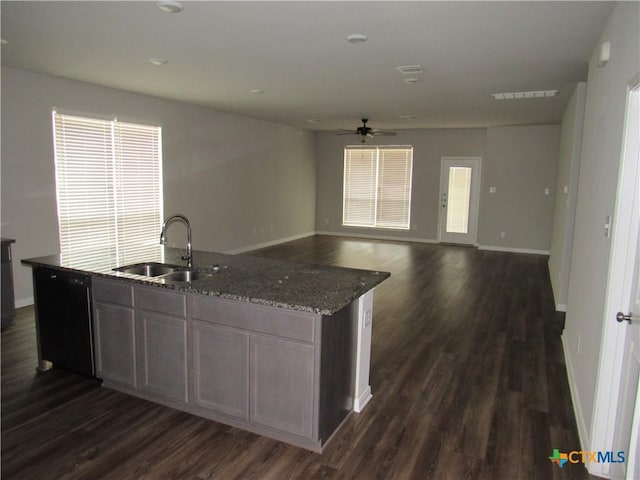 10018 Kensley Rose Dr, Killeen, TX 76542 - kitchen featuring black dishwasher, a ceiling fan, dark wood-style floors, and a center island with sink