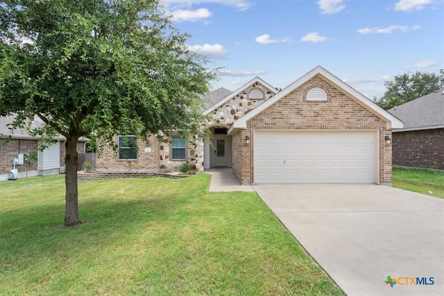 215 Sheridan Loop, Belton, TX 76513 - ranch-style house with an attached garage, driveway, brick siding, and a front lawn