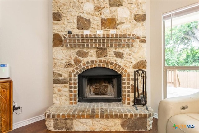215 Sheridan Loop, Belton, TX 76513 - detailed view of wood finished floors and a fireplace with raised hearth