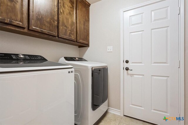 215 Sheridan Loop, Belton, TX 76513 - laundry room with cabinet space, washing machine and clothes dryer, and light tile patterned floors