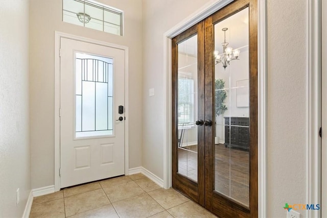215 Sheridan Loop, Belton, TX 76513 - entrance foyer featuring french doors, light tile patterned floors, a chandelier, and plenty of natural light