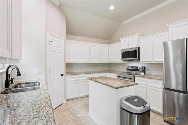 215 Sheridan Loop, Belton, TX 76513 - kitchen with stainless steel appliances, lofted ceiling, a kitchen island, white cabinets, and light tile patterned floors