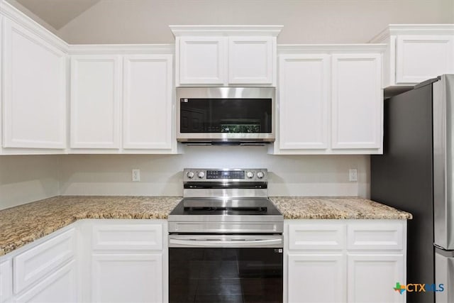 215 Sheridan Loop, Belton, TX 76513 - kitchen featuring stainless steel appliances, white cabinets, light stone countertops, and lofted ceiling