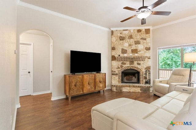 215 Sheridan Loop, Belton, TX 76513 - living room with ornamental molding, ceiling fan, wood finished floors, arched walkways, and a fireplace