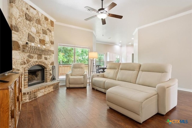 215 Sheridan Loop, Belton, TX 76513 - living area with ornamental molding, dark wood-style flooring, ceiling fan, and a stone fireplace