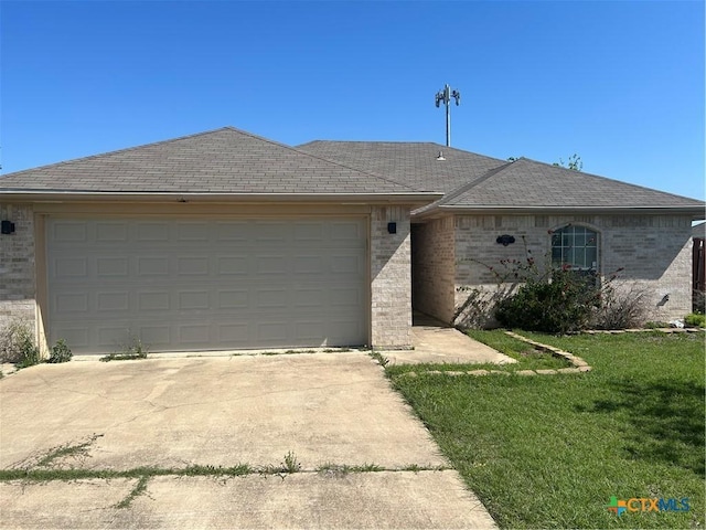 view of front of home featuring a front yard, a garage, brick siding, driveway, and roof with shingles