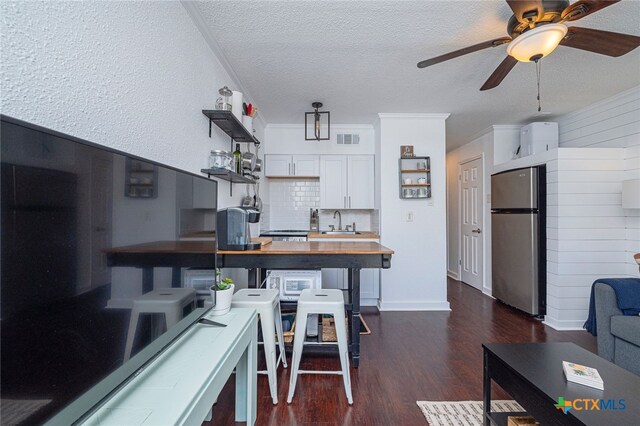 3938 Surfside Blvd Unit 3116, Corpus Christi, TX 78402 - kitchen featuring freestanding refrigerator, wooden counters, a sink, dark wood-style floors, and a textured ceiling