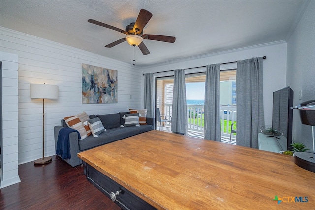 3938 Surfside Blvd Unit 3116, Corpus Christi, TX 78402 - living room with dark wood-style floors, crown molding, a ceiling fan, a textured ceiling, and wood walls