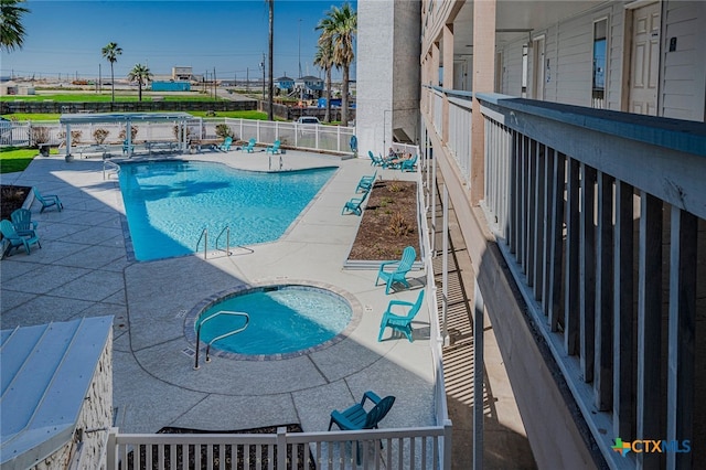 3938 Surfside Blvd Unit 3116, Corpus Christi, TX 78402 - community pool with a patio and a fenced backyard