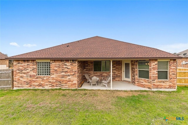 rear view of house featuring a patio and a yard