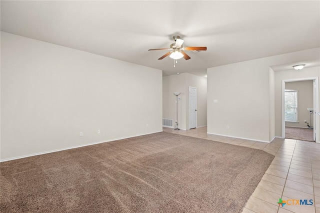 unfurnished room with ceiling fan and light tile patterned flooring