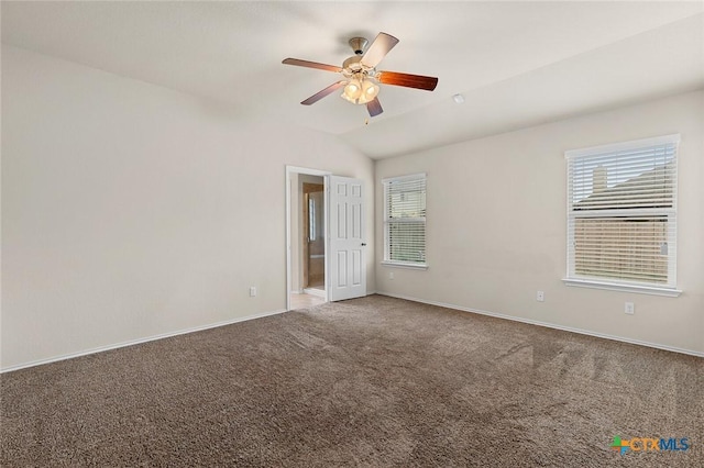 empty room with lofted ceiling, carpet floors, and a healthy amount of sunlight