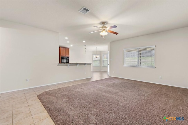 unfurnished living room with light tile patterned floors and ceiling fan