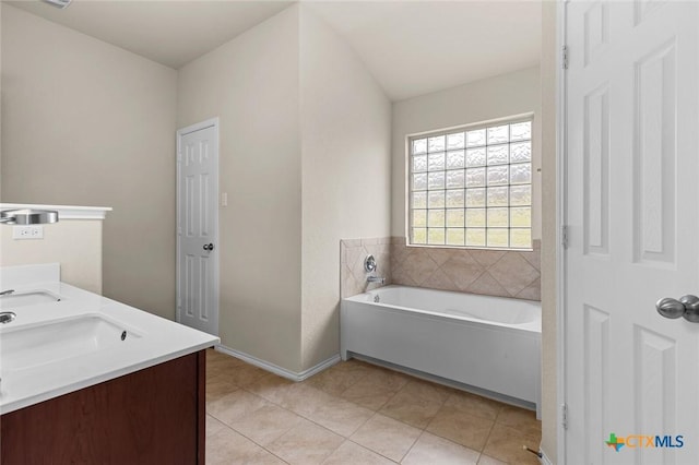 bathroom featuring tile patterned flooring, vanity, and a bathtub