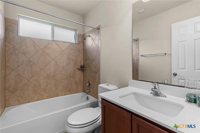 full bathroom with vanity, toilet, and tiled shower / bath combo