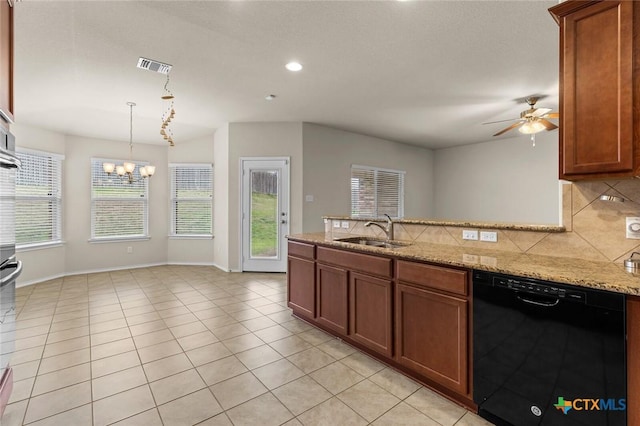 kitchen with light stone counters, black dishwasher, sink, and tasteful backsplash