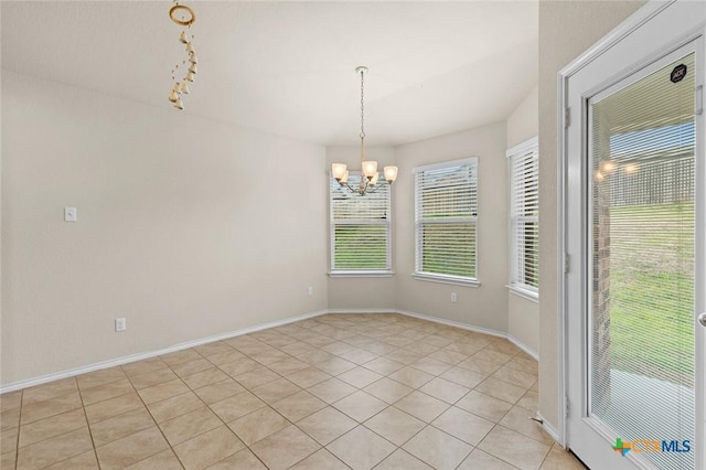 unfurnished room with an inviting chandelier