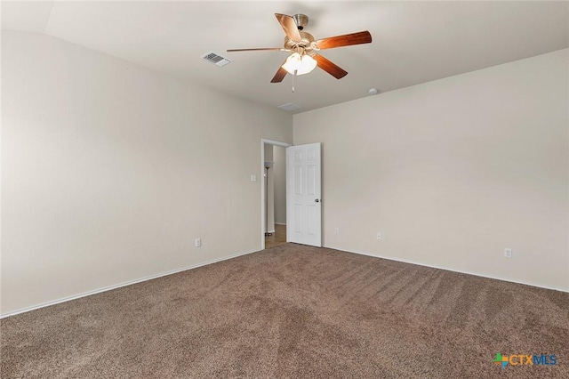 empty room featuring ceiling fan and carpet