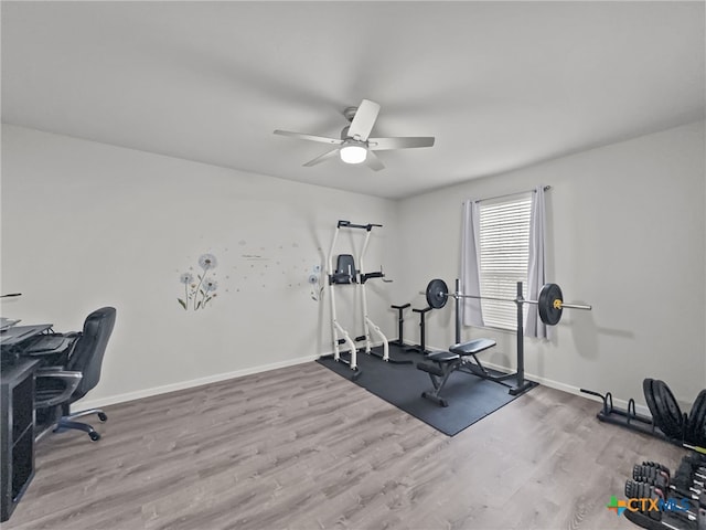 exercise room featuring ceiling fan, wood finished floors, and baseboards